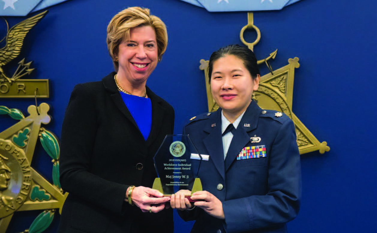 Then–Under Secretary of Defense for Acquisition and Sustainment, Ellen M. Lord, and U.S. Air Force Major Jenny W. Ji pose for photo following Ji receiving Defense Acquisition Workforce Individual Achievement Award for Acquisitions in an Expeditionary Environment, at the Pentagon,
February 5, 2019 (DOD/Amber I. Smith)